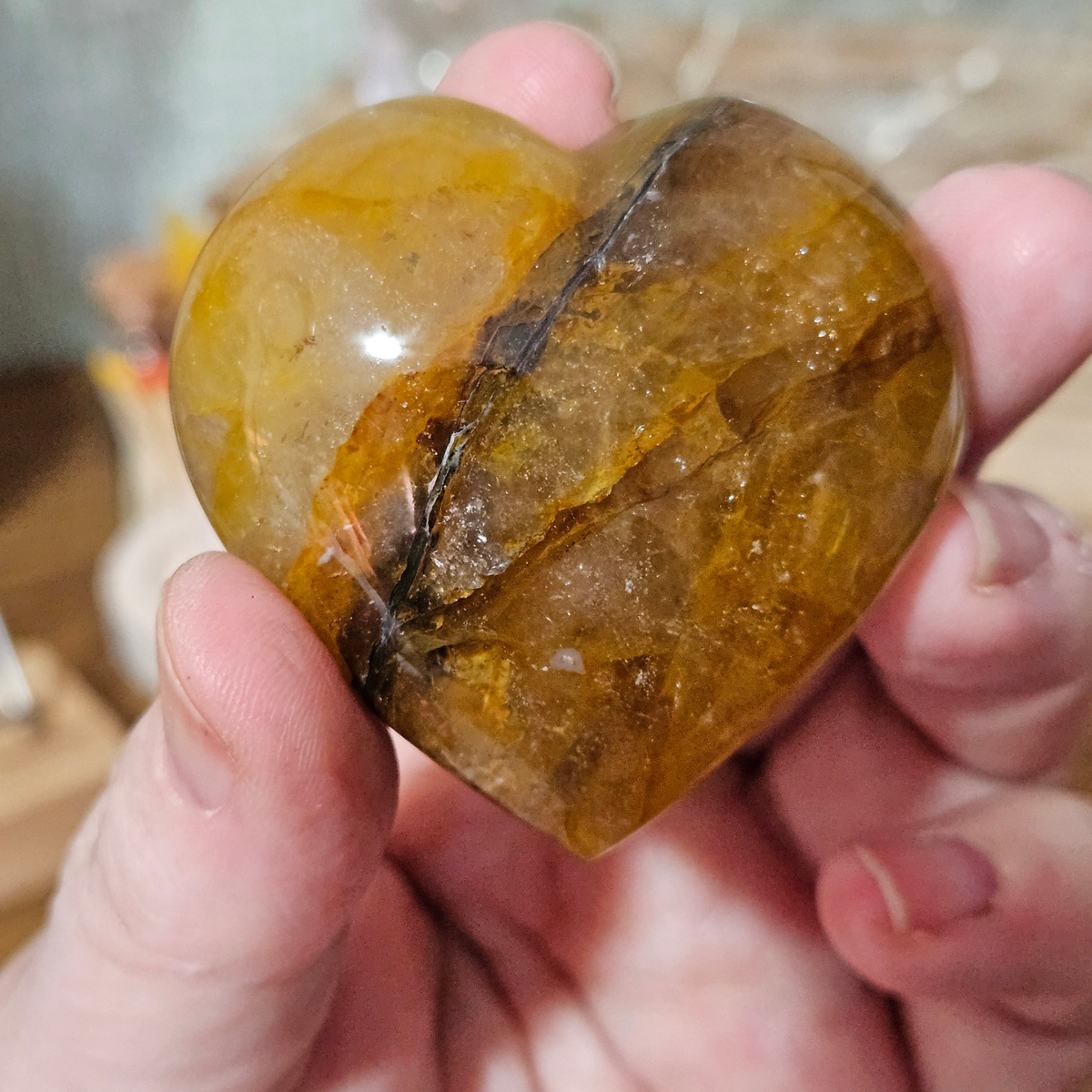50mm Golden Healer Quartz heart with dramatic dark mineral inclusion and deep golden quartz.